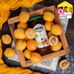 Overhead perspective of 300g Apricot Jam jar, displaying the lid and fresh peach texture.